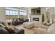 Cozy living room with a fireplace, large windows, plush seating, and scenic views at 16002 E 111Th Cir, Commerce City, CO 80022