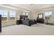 Bright main bedroom suite with large windows offering scenic golf course views at 16002 E 111Th Cir, Commerce City, CO 80022