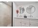 Bright bathroom featuring a glass shower, dual sinks, and modern finishes at 3500 W 55Th Ave, Denver, CO 80221