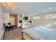 Large bedroom featuring built-in shelving, a flatscreen TV, and comfortable modern chair at 3500 W 55Th Ave, Denver, CO 80221