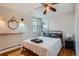 Charming bedroom featuring hardwood floors, natural light, and a ceiling fan at 3500 W 55Th Ave, Denver, CO 80221