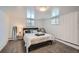 Cozy bedroom with white walls, carpeted floors, and natural light from two windows at 3500 W 55Th Ave, Denver, CO 80221