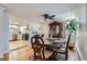 Formal dining area with hardwood floors, elegant furnishings, and views into the updated kitchen at 3500 W 55Th Ave, Denver, CO 80221