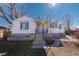 Charming single-story home with white stucco and stone accents, inviting curb appeal, and a well-maintained front yard at 3500 W 55Th Ave, Denver, CO 80221