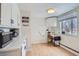 Bright kitchen area features a small desk, modern countertops, and white cabinets at 3500 W 55Th Ave, Denver, CO 80221