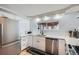 Contemporary kitchen featuring stainless steel appliances, white cabinets, quartz countertops, and a functional layout at 3500 W 55Th Ave, Denver, CO 80221