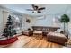 Bright living room showcasing hardwood floors, a comfortable leather sectional, and ample natural light at 3500 W 55Th Ave, Denver, CO 80221