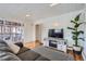 Comfortable living room showcasing hardwood floors, access to a deck, and modern decor at 3500 W 55Th Ave, Denver, CO 80221