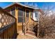 Wooden screened-in porch with steps leading to a fenced-in backyard at 3500 W 55Th Ave, Denver, CO 80221