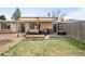 Backyard featuring a covered patio with outdoor furniture, planters and a well-maintained lawn at 2211 Lamar St, Edgewater, CO 80214