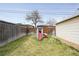 Spacious backyard with a green lawn, a wooden fence, and a slide at 2211 Lamar St, Edgewater, CO 80214