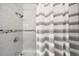 Clean bathroom featuring tiled shower, stylish shower curtain and modern fixtures at 2211 Lamar St, Edgewater, CO 80214