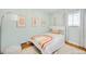 Bright bedroom featuring a rainbow-themed bed, white floors and walls, and natural light from the window at 2211 Lamar St, Edgewater, CO 80214