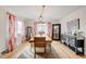 Bright dining room with hardwood floors, stylish chandelier, large mirror and an elegant wooden table set for eight at 2211 Lamar St, Edgewater, CO 80214