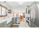 Beautiful kitchen with open layout, white cabinetry, stainless steel appliances, and modern finishes at 2211 Lamar St, Edgewater, CO 80214