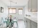 View of the kitchen with table, chairs, and light gray cabinets with bright white countertops at 2211 Lamar St, Edgewater, CO 80214