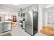 Beautiful kitchen with white cabinetry, stainless steel appliances, and access to the dining area at 2211 Lamar St, Edgewater, CO 80214