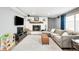 Spacious living room with a painted brick fireplace and neutral-colored walls, sofa, and rug at 2211 Lamar St, Edgewater, CO 80214
