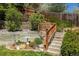 Multi-tiered backyard with garden beds and a wooden staircase at 10856 Parker Vista Ln, Parker, CO 80138