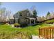 Expansive backyard with lush lawn, mature trees, and a covered patio at 10856 Parker Vista Ln, Parker, CO 80138