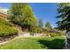 Beautiful backyard features a manicured lawn and tiered garden beds at 10856 Parker Vista Ln, Parker, CO 80138