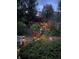 Backyard with tiered gardens, wood retaining walls, stairs, and landscape lighting at 10856 Parker Vista Ln, Parker, CO 80138