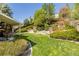 Large landscaped backyard with tiered retaining walls and outdoor seating at 10856 Parker Vista Ln, Parker, CO 80138