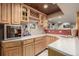 Basement bar area with custom cabinetry, a wine cooler and storage for glasses at 10856 Parker Vista Ln, Parker, CO 80138