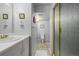 Bathroom with white vanity, brushed gold fixtures, tile floor and glass shower at 10856 Parker Vista Ln, Parker, CO 80138