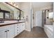 A bathroom with a double sink vanity, a shower, and neutral-toned flooring at 10856 Parker Vista Ln, Parker, CO 80138