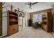 Bedroom with neutral carpet, ceiling fan, desk area with a window, and bookshelf at 10856 Parker Vista Ln, Parker, CO 80138