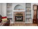 A detailed view of the brick fireplace with white shelving on each side at 10856 Parker Vista Ln, Parker, CO 80138