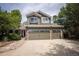 Lovely two-story home with a three-car garage, brick accents, and a well-maintained lawn and garden at 10856 Parker Vista Ln, Parker, CO 80138