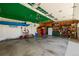 Spacious garage with a vibrant green ceiling, lots of storage, and a blue kayak at 10856 Parker Vista Ln, Parker, CO 80138