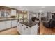 An open kitchen with a central island, hardwood floors, and an adjacent dining/living area at 10856 Parker Vista Ln, Parker, CO 80138