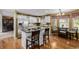 Open kitchen with hardwood floors, an island with seating, stainless steel appliances, and a sunny breakfast nook at 10856 Parker Vista Ln, Parker, CO 80138