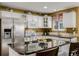 A cozy kitchen featuring granite countertops, white cabinetry, and stainless steel appliances at 10856 Parker Vista Ln, Parker, CO 80138