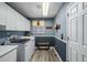 Bright laundry room features modern washer, dryer, storage cabinets, and decor at 10856 Parker Vista Ln, Parker, CO 80138