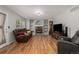 A comfortable living room featuring a brick fireplace, hardwood floors, and a bay window at 10856 Parker Vista Ln, Parker, CO 80138