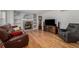 A living room with a brick fireplace, hardwood floors, and comfortable seating at 10856 Parker Vista Ln, Parker, CO 80138