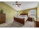 A large bedroom featuring neutral carpet, natural light, and a ceiling fan at 10856 Parker Vista Ln, Parker, CO 80138