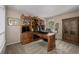 A spacious home office with built-in shelves and a large wooden desk at 10856 Parker Vista Ln, Parker, CO 80138