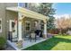 Charming covered patio with stone pillars, a grill, and backyard views at 10856 Parker Vista Ln, Parker, CO 80138