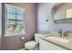 Stylish bathroom with a modern vanity, contemporary mirror, and natural light at 7998 E Vassar Dr, Denver, CO 80231