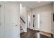 Inviting foyer featuring hardwood floors, a staircase, and a welcoming entrance at 7998 E Vassar Dr, Denver, CO 80231