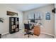 Cozy home office space with a built in bookshelf, a desk and a chair at 7998 E Vassar Dr, Denver, CO 80231