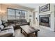 Cozy living room featuring a fireplace, comfortable seating, and lots of natural light at 7998 E Vassar Dr, Denver, CO 80231