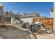 Backyard with a brick patio that's ideal for outdoor dining with patio furniture and string lights at 7998 E Vassar Dr, Denver, CO 80231