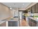 A kitchen with stainless steel appliances, granite countertops and dark wood cabinets at 861 Circle, Palmer Lake, CO 80133