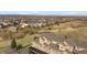 An aerial view of townhomes in a residential community with mountain views and many manicured lawns at 3661 S Perth Cir # 6-101, Aurora, CO 80013
